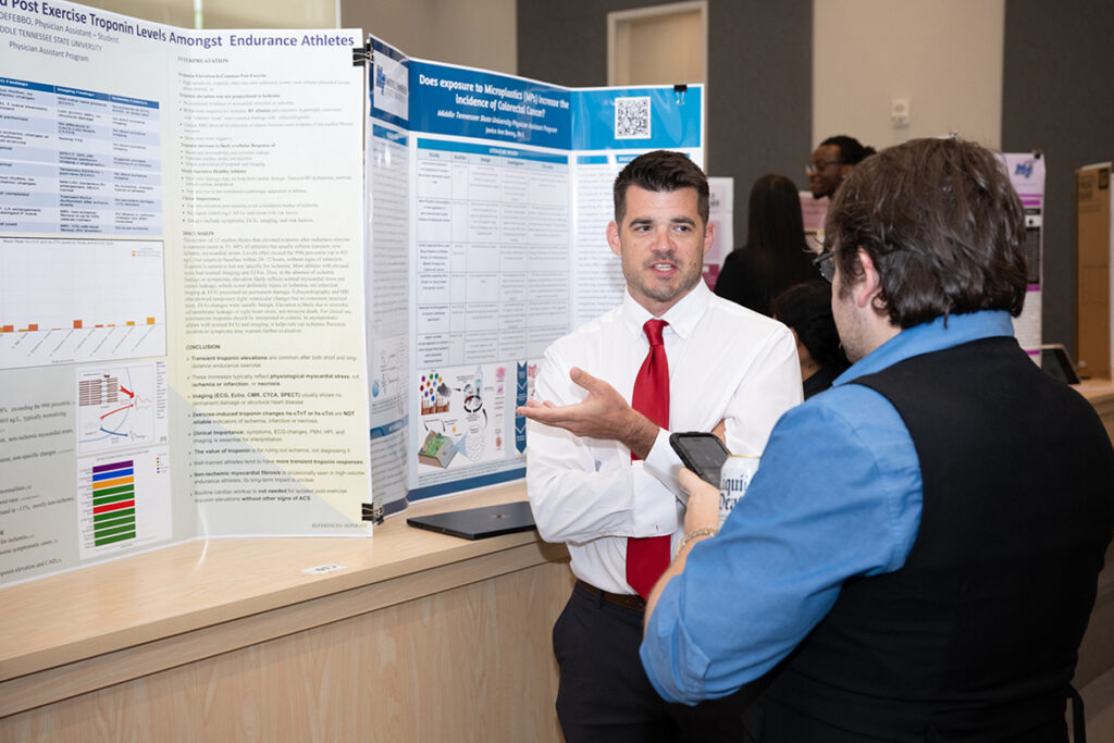 William “Brad” McCrary, right, assistant professor in Physician Assistant Studies and director of didactic education for the program at Middle Tennessee State University in Murfreesboro, Tenn., listens to student John DeFebbo discuss his first-year research project at the 2025 Capstone and Poster Symposium held on campus. This year’s event, when DeFebbo will give his final research presentation, is 11:30 a.m. to 4:30 p.m. Friday, July 31, in the Academic Classroom Building, 1751 MTSU Blvd. (MTSU file photo by James Cessna)
