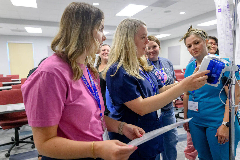 Rutherford County Schools nurses, from left, Whitney Smith, Allison Wadham, Tesha Martin and Gena Schmahl learn how to program a feeding tube pump during the School Nurse Skills Day hosted in June at MTSU’s School of Nursing. (MTSU photo by J. Intintoli)