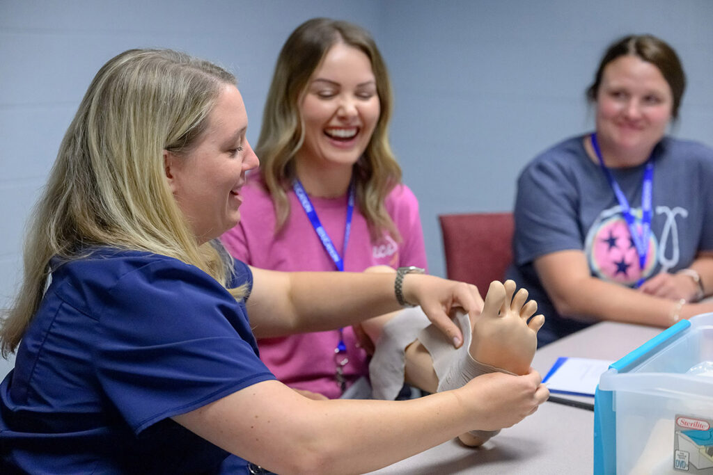 Rutherford County Schools nurses Allison Wadham, left, Whitney Smith, center, and Tesha Martin work on first-aid techniques on an artificial limb during the School Nurse Skills Day hosted in June at Middle Tennessee State University School of Nursing in Murfreesboro, Tenn. (MTSU photo by J. Intintoli)
