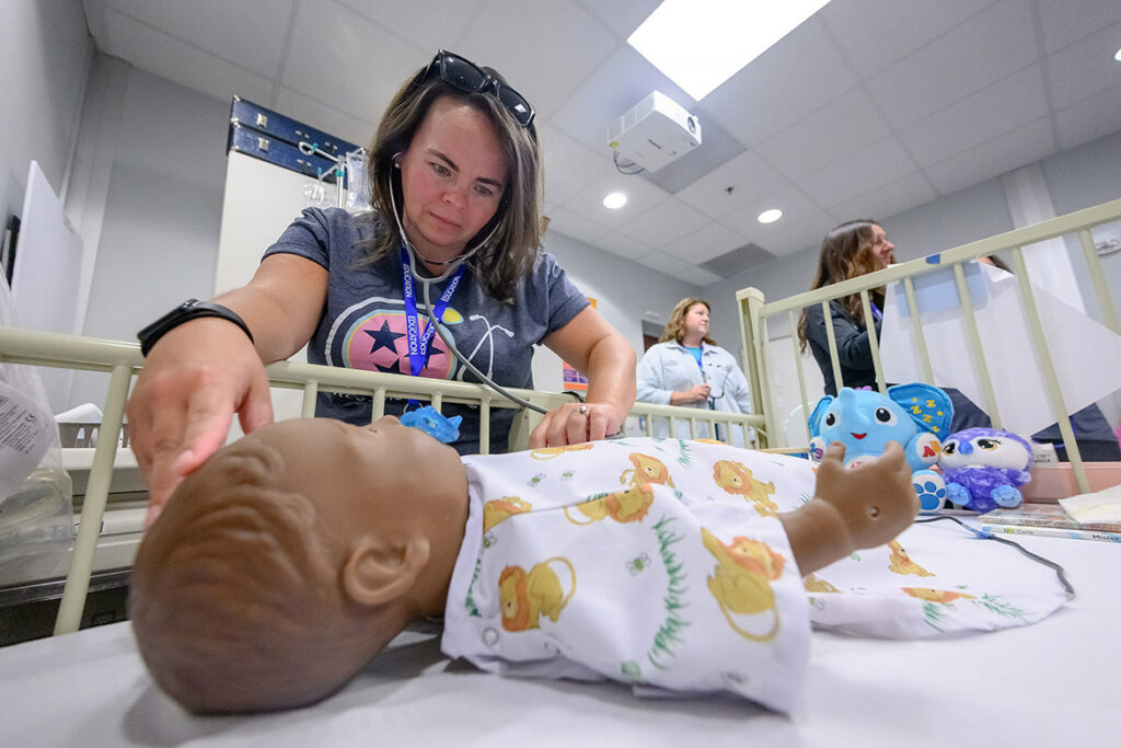 Rutherford County Schools nurse Keisha Newport checks a high-fidelity pediatric mannequin for any signs of asthma distress during School Nurse Skills Day hosted in June at Middle Tennessee State University School of Nursing in Murfreesboro, Tenn. (MTSU photo by J. Intintoli)
