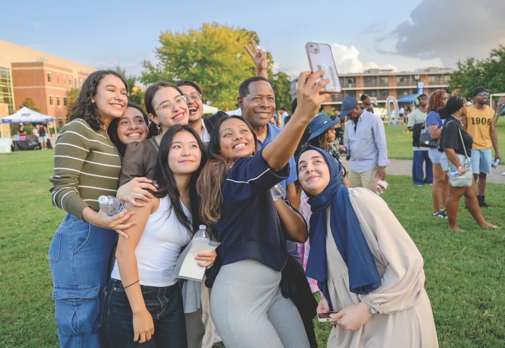 McPhee posing with students returning to school