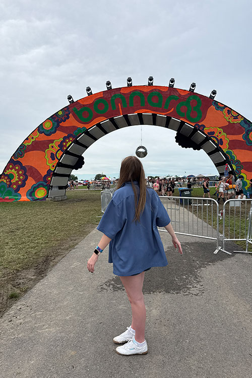 Middle Tennessee State University MBA student Ella Cobb poses in front of the Bonnaroo rainbow at the Bonnaroo Music and Arts Festival in Manchester, Tenn. (Submitted Photo)