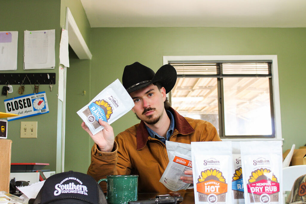 In this undated photo, Beckham Scott, a public relations major at Middle Tennessee State University in Murfreesboro, Tenn., holds bags of sunflower seeds produced by the Southern Sunflower Seed Co. that he launched with his longtime friend Levi Melton in 2025. (Submitted photo)