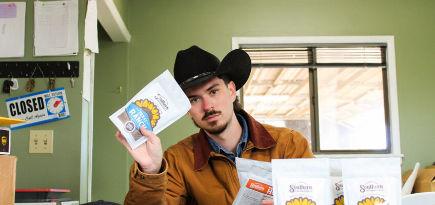 In this undated photo, Beckham Scott, a public relations major at Middle Tennessee State University in Murfreesboro, Tenn., holds bags of sunflower seeds produced by the Southern Sunflower Seed Co. that he launched with his longtime friend Levi Melton in 2025. (Submitted photo)