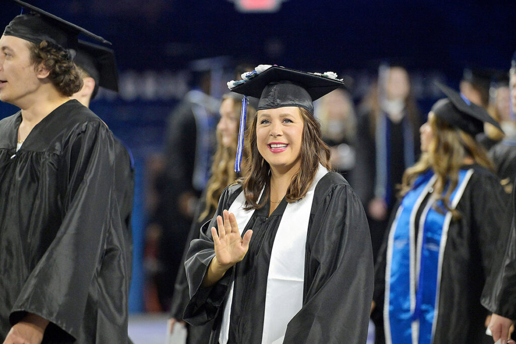 Middle Tennessee State University Class of 2026 graduate Chelsey Voyles, an English major from Smyrna, Tenn., waves as she heads to the stage to receive her diploma during the summer commencement ceremony held Saturday, Aug. 8, 2026, inside Murphy Center on campus in Murfreesboro, Tenn. (MTSU photo by Andy Heidt)