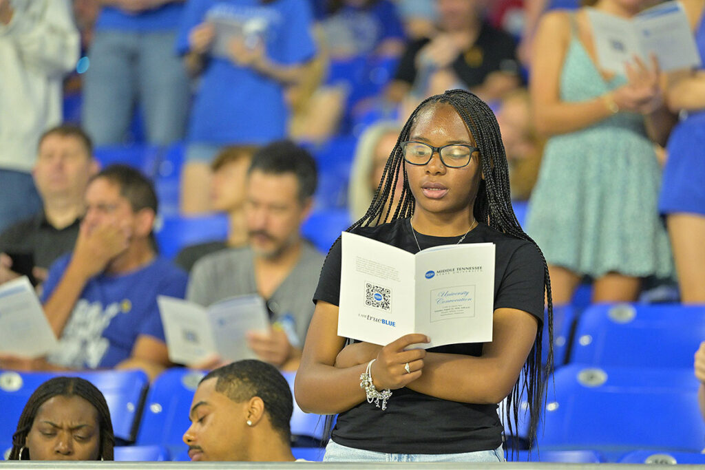 A new Middle Tennessee State University student joins the crowd in reciting the “True Blue Pledge” of core values during the 25th annual Convocation ceremony held Saturday, Aug. 22, inside Murphy Center on campus in Murfreesboro, Tenn. (MTSU photo by James Cessna)