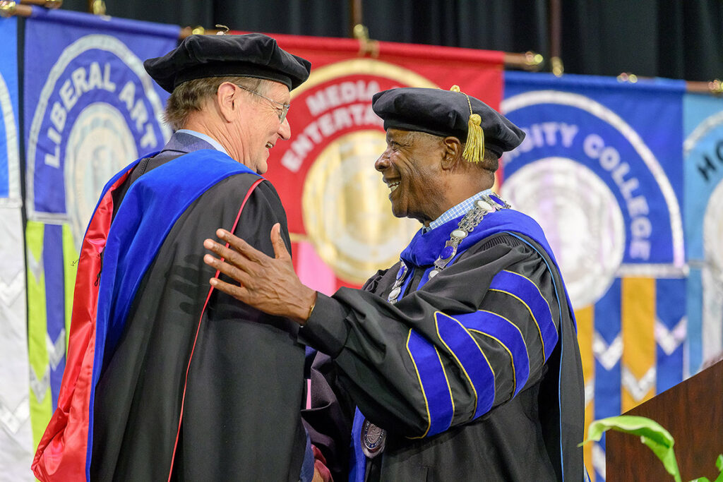 Middle Tennessee State University President Sidney A. McPhee, right, greets 2026 Convocation speaker Edward J. Larson, Pulitzer Prize-winning author of the summer reading book “Declaring Independence: Why 1776 Matters,” on stage at the 25th annual event held Saturday, Aug. 22, inside Murphy Center on campus in Murfreesboro, Tenn. (MTSU photo by Andy Heidt)