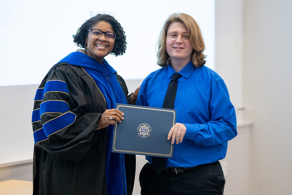 Ethan Estes, right, is presented a certificate by Leah Tolbert Lyons, dean of the College of Liberal Arts at Middle Tennessee State University in Murfreesboro, Tenn., when Estes was inducted into Phi Kappa Phi Honor Society in 2024. A 2025 graduate with a history degree, Estes has been awarded an $8,500 Phi Kappa Phi fellowship. (MTSU file photo by Cat Curtis Murphy)