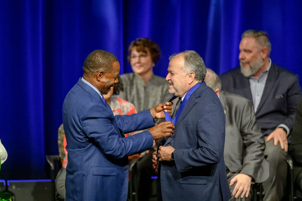 Middle Tennessee State University President Sidney A. McPhee awards School of Music professor Lalo Davila with the MTSU Foundation’s Career Achievement Award during the university’s annual Fall Faculty Meeting on Thursday, Aug. 20, 2026, inside Tucker Theatre on campus in Murfreesboro, Tenn. (MTSU photo by J. Intintoli)
