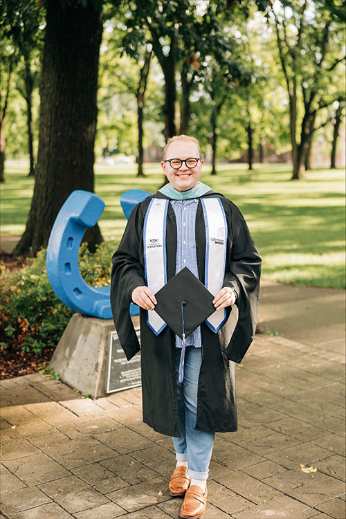 Shown here in his academic regalia in front of the blue horseshoe in Walnut Grove on the campus of Middle Tennessee State University in Murfreesboro, Tenn., Jared McGee graduated Saturday, Aug. 8, 2026, with his master’s degree in higher education. He was among the nearly 700 graduates celebrated at MTSU’s summer commencement ceremony in Murphy Center. (Photo submitted)