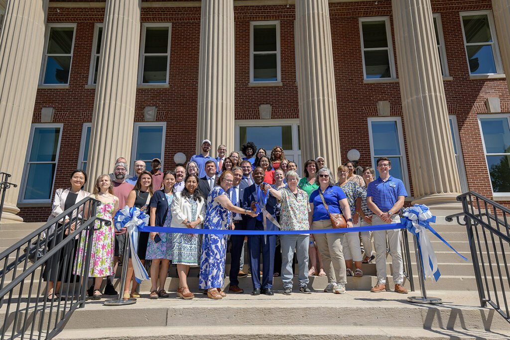 Middle Tennessee State University President Sidney A. McPhee, at center holding scissors, is joined by Provost Mark Byrnes and faculty members from the departments of Computer Science and Mathematical Sciences on the steps of Kirksey Old Main on Tuesday, Aug. 18, for the ribbon-cutting to celebrate the grand reopening of the newly updated building on campus in Murfreesboro, Tenn. (MTSU photo by Andy Heidt)