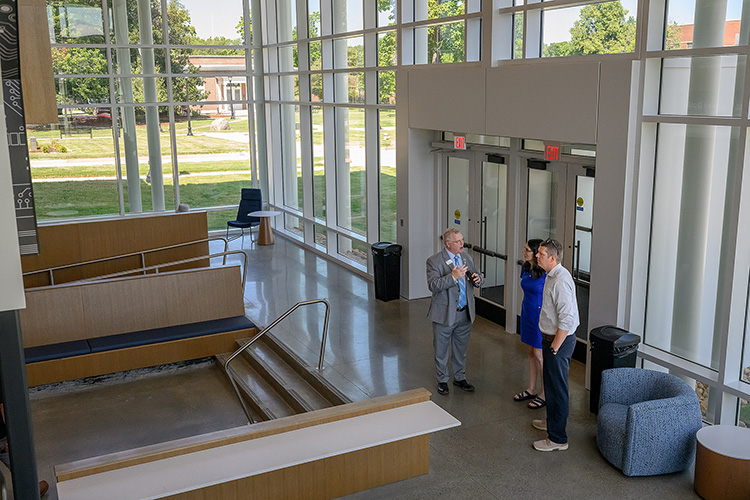 A trio stands together in the brand new lobby of the recently renovated Kirksey Old Main building.