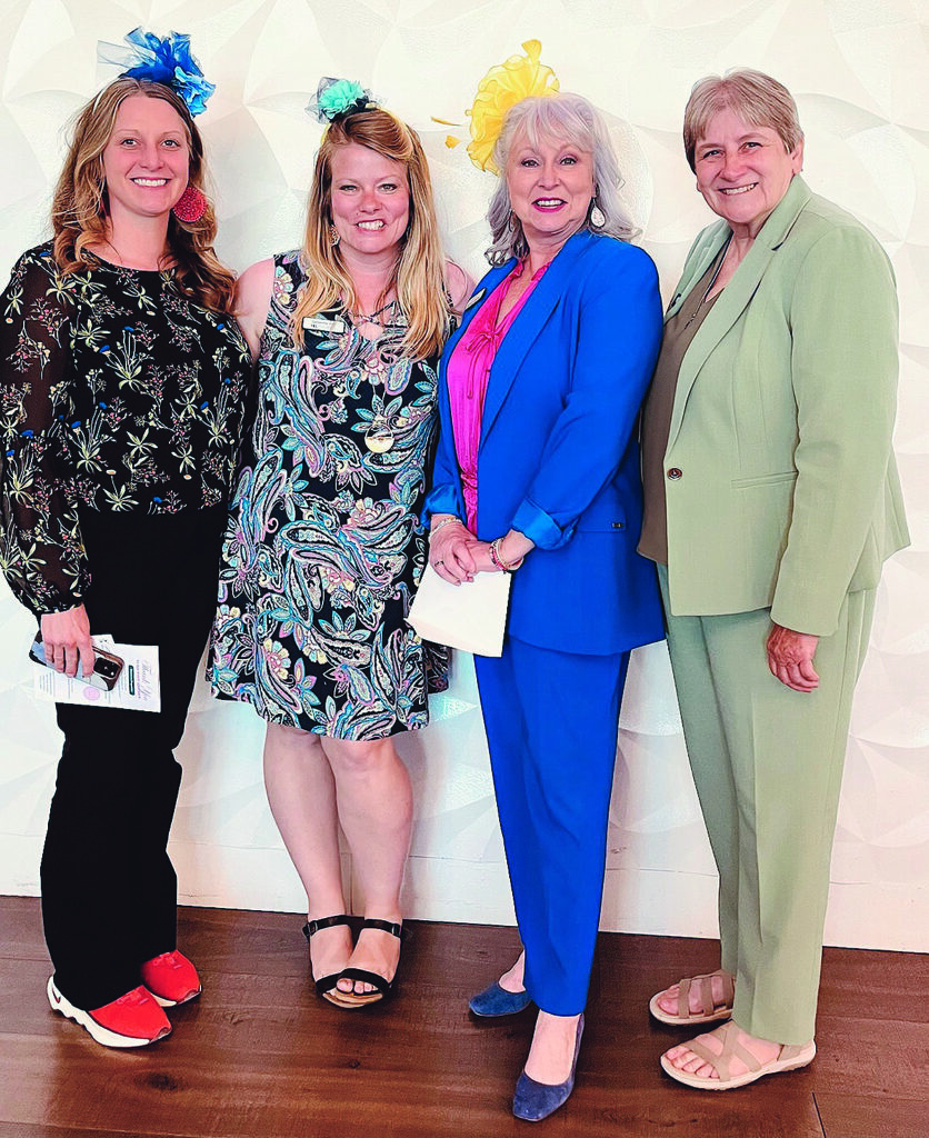 Posing in their decorative hats for the annual American Association of University Women EqualiTEA fundraiser are League of Women Voters of Murfreesboro/Rutherford County members, from left, Andrea Bell, Sam Weir, Lee Anne Carmack and Nancy James. (Submitted photo)