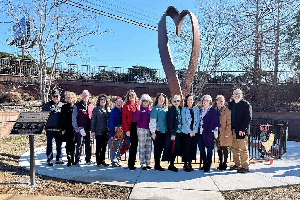 Middle Tennessee State University College of Liberal Arts advisor Lee Anne Carmack, seventh from left, stands with fellow members of the Rutherford Arts Alliance at a ribbon-cutting ceremony for the HeArt of Tennessee” sculpture created by MTSU art professor Michael Baggarly that was installed at the Discovery Center at Murfree Spring in Murfreesboro, Tenn., on Feb. 9, 2026. (Submitted photo)