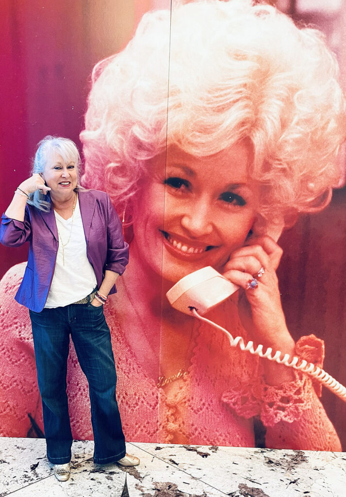 Middle Tennessee State University College of Liberal Arts advisor Lee Anne Carmack, the new co-president of the League of Women Voters of Murfreesboro/Rutherford County, stands in front of the playbill poster of “Dolly: The Musical,” at the 2025 Belmont University production in Nashville, Tenn. (Submitted)