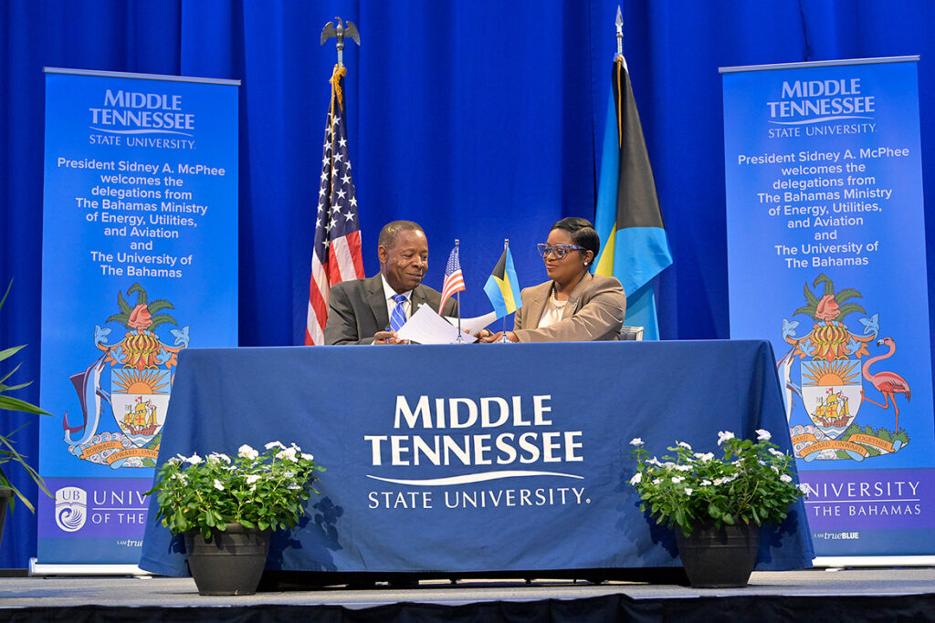 Middle Tennessee State University President Sidney A. McPhee, left, and JoBeth Coleby-Davis, minister of energy, utilities and aviation for the Bahamas, exchange signatures on an aerospace education agreement between the university and the commonwealth during a signing ceremony held Thursday, Aug. 13, in the MTSU Student Union Ballroom on campus in Murfreesboro, Tenn. (MTSU photo by Andy Heidt)