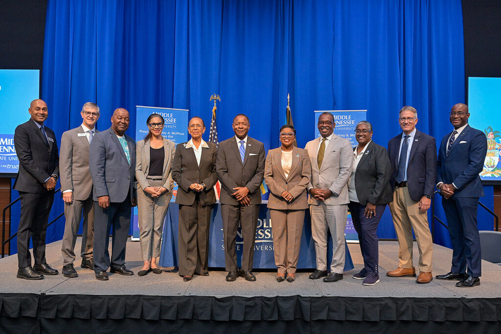 Middle Tennessee State University President Sidney A. McPhee, center left, and JoBeth Coleby-Davis, minister of energy, utilities and aviation for the Bahamas, center right, are joined by other representatives from both institutions for a group photo following a signing ceremony for an aerospace education partnership held Thursday, Aug. 13, 2026, in the MTSU Student Union Ballroom on campus in Murfreesboro, Tenn. (MTSU photo by Andy Heidt)