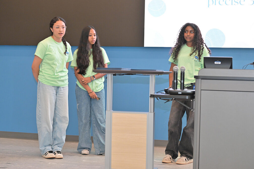 Three rising ninth through 12th graders who participated in the third annual National Summer Transportation Institute hosted by Middle Tennessee State University in Murfreesboro, Tenn., give a presentation at the institute’s closing ceremony on July 31, 2026, in the Applied Engineering Building on campus. (MTSU photo by James Cessna)