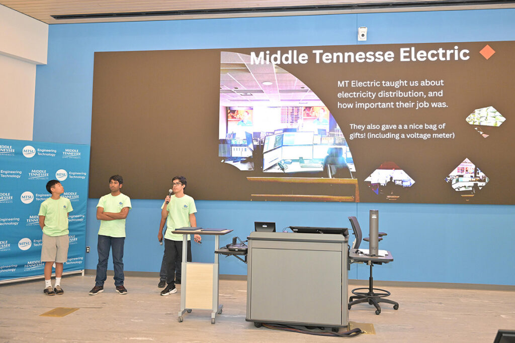 Three rising ninth through 12th graders who participated in the third annual National Summer Transportation Institute hosted by Middle Tennessee State University in Murfreesboro, Tenn., give a presentation at the institute’s closing ceremony on July 31, 2026, in the Applied Engineering Building on campus. (MTSU photo by James Cessna)