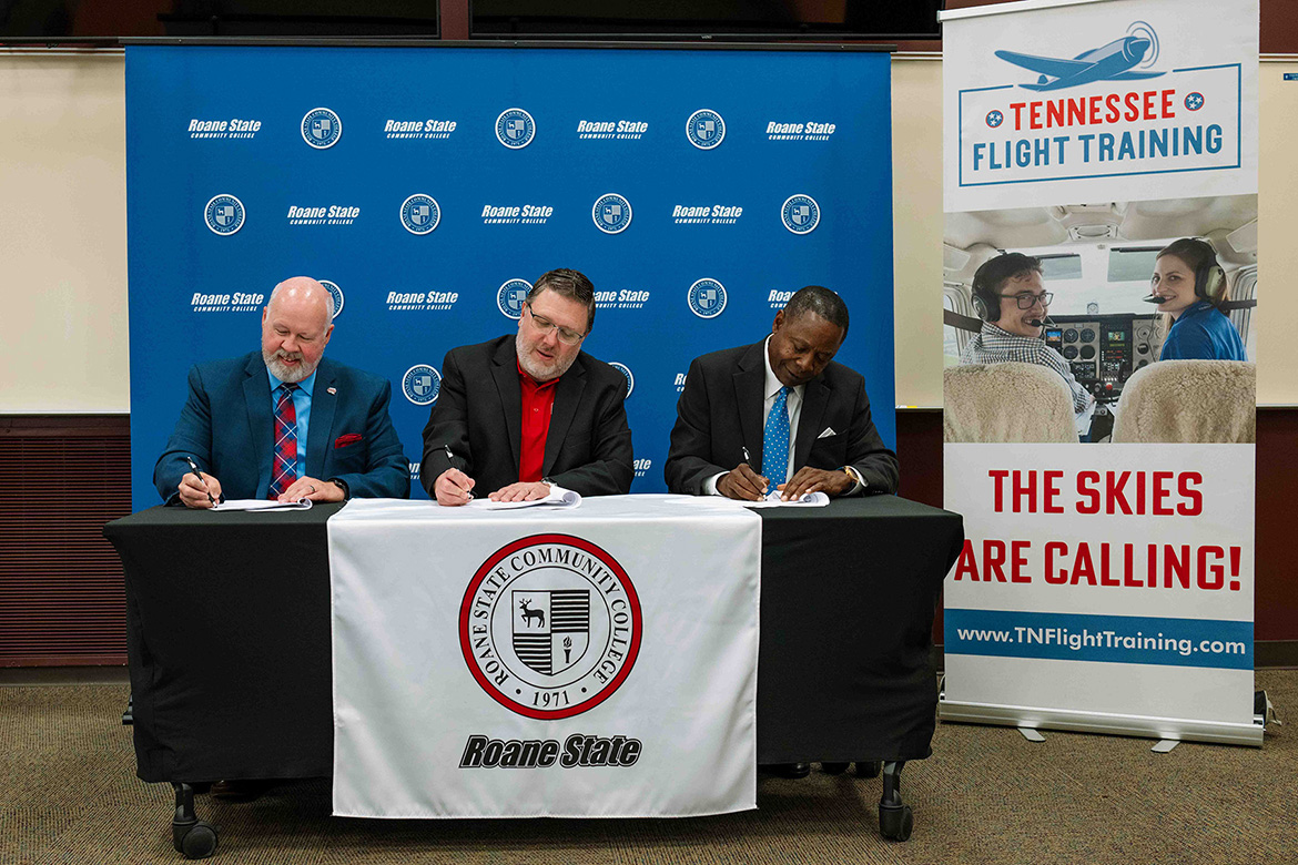 From left, Roane State Community College President Chris Whaley, Tennessee Flight Training President Chris Erlanson, and Middle Tennessee State University President Sidney A. McPhee sign an articulation agreement on Aug. 6, 2026, at Roane’s campus in Harriman, Tenn. The agreement supports streamlined transfer opportunities for students pursuing two of the community college’s newest offerings — aerospace and fire science. (Courtesy of Roane State Community College)