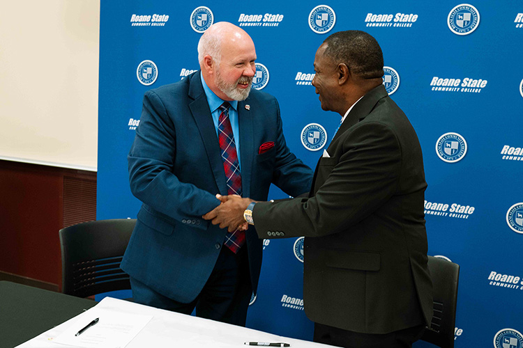 Roane State Community College President Chris Whaley, left, and Middle Tennessee State University President Sidney A. McPhee shake hands after signing an articulation agreement on Aug. 6, 2026, at Roane’s campus in Harriman, Tenn. The agreement supports streamlined transfer opportunities for students pursuing two of the community college’s newest offerings — aerospace and fire science. (Courtesy of Roane State Community College)