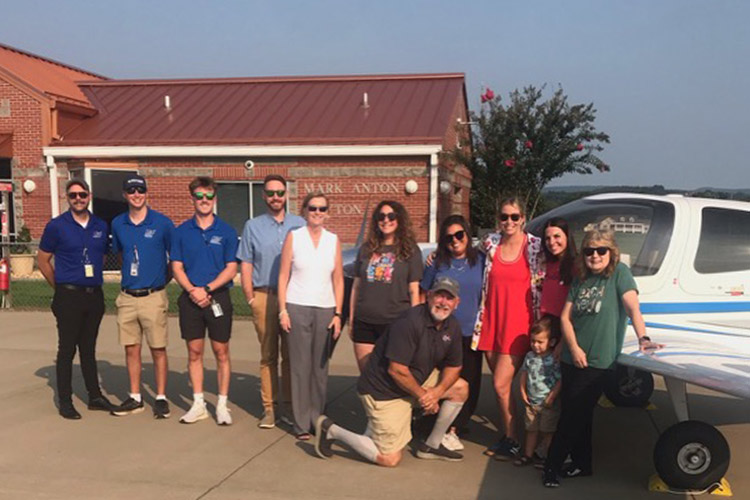 A group of teachers from Rhea County, Tennessee and flight instructors from Middle Tennessee State University pose together outside of Mark Anton Airport in Dayton, Tennessee.