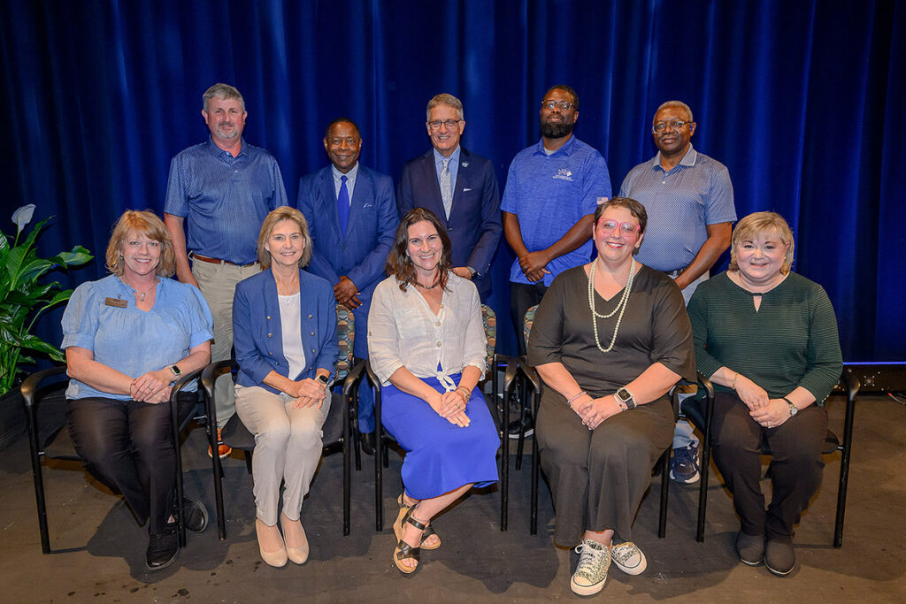 Middle Tennessee State University President Sidney A. McPhee, back row, second from left, poses with the nine recipients of the President’s Silver Column Award after the 2026 Fall Faculty and Staff Meeting held Thursday, Aug. 20, in Tucker Theatre on campus in Murfreesboro, Tenn. Pictured, front row, from left, are Allison McGoffin, assistant to the University Provost; Ronda Vaughter, assistant vide president for Academic Services; Kate Pantelides, English professor; Amanda Witt, project manager with Construction Renovation Services; Cindy Johnson, associate registrar; and back row, from left, David Edgar, manager of University Space Management; McPhee; Provost Mark Byrnes; Chris Rochelle, assistant director of Charlie and Hazel Daniels Veterans and Military Family Center; and Franck Mukendi, information technology specialist. (MTSU photo by Andy Heidt)