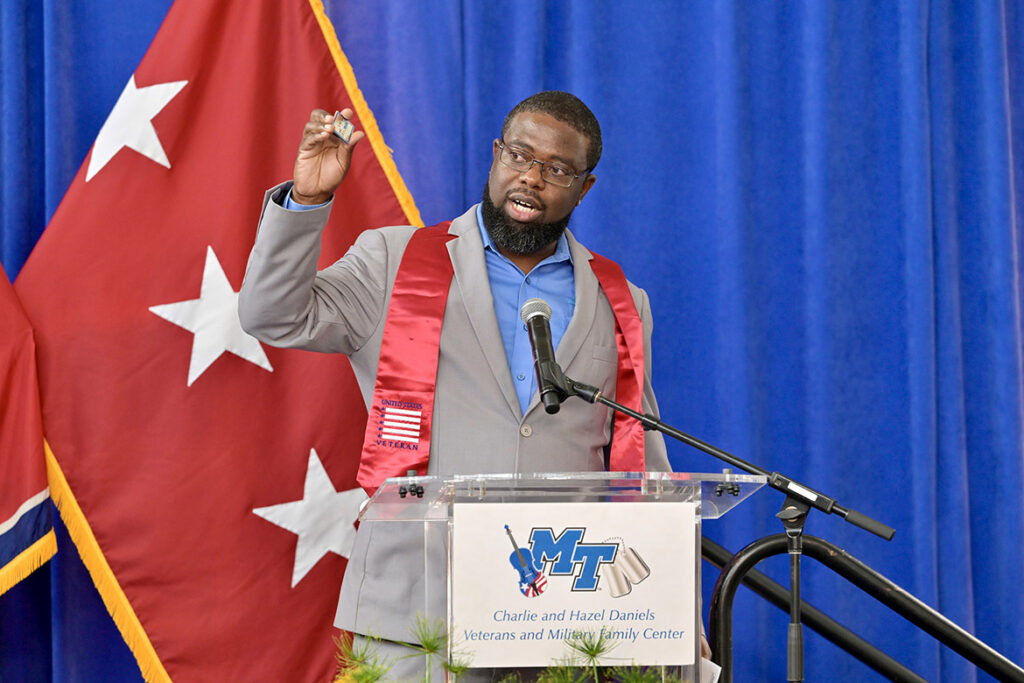 Chris Rochelle, assistant director of the Charlie and Hazel Daniels Veterans and Military Family Center at Middle Tennessee State University in Murfreesboro, Tenn., speaks to the crowd gathered on Thursday, Aug. 6, in the atrium of Miller Education Center for the 34th Graduating Veterans Stole Ceremony celebrating student veterans. (MTSU photo by Andy Heidt)
