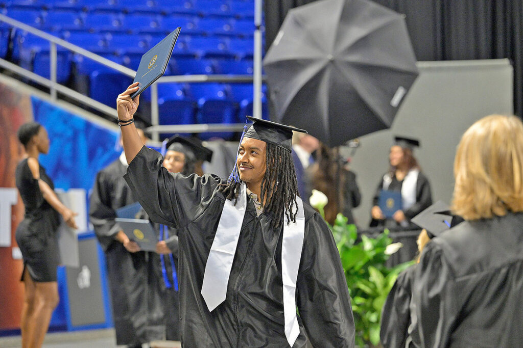 A proud Middle Tennessee State University Class of 2026 graduate holds up his diploma cover after crossing the stage during the summer commencement ceremony held Saturday, Aug. 8, 2026, inside Murphy Center on campus in Murfreesboro, Tenn. (MTSU photo by Andy Heidt)