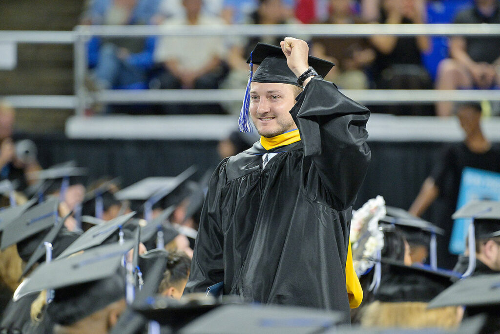 With his diploma tucked under his arm, a proud Class of 2026 graduate gives a celebratory fist pump during the summer commencement ceremony held Saturday, Aug. 8, 2026, inside Murphy Center at Middle Tennessee State University in Murfreesboro, Tenn. (MTSU photo by Andy Heidt)