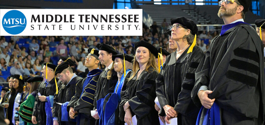 MTSU doctoral recipients and professors standing in a row in Murphy Center.