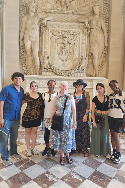 From left, Middle Tennessee State University students Kevin Peralta, Ella Russell, Betty Remy, Michelle Halman, Julia Marcella and Rennee Tetteh pose for a photo with MTSU professor Joan McRae, center, at the Louvre Museum in Paris, France, as part of their study abroad trip over the summer. (Submitted photo)