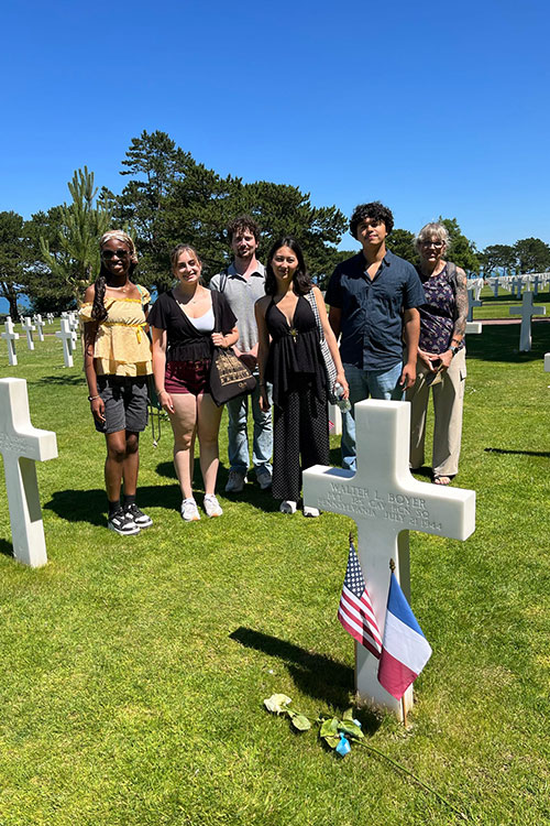 From left, Middle Tennessee State University studentsRennee Tetteh, Ella Russell, Justin McNaught, Julia Marcella, Kevin Peralta and Michelle Halman pose for a photo beside a grave marker at the Normandy American Cemetery in Colleville-sur-Mer, France, as part of their study abroad trip over the summer. (Submitted photo)