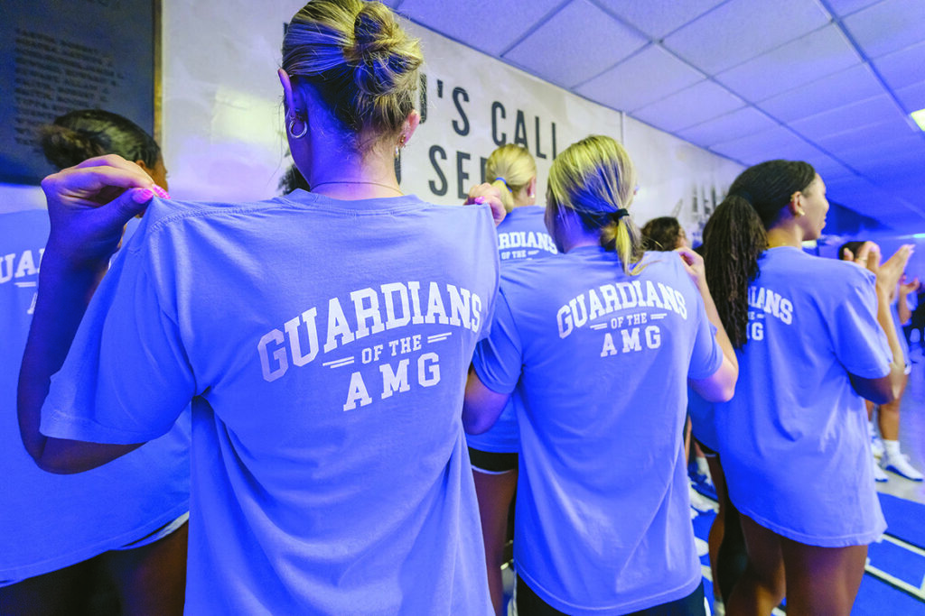 On Wednesday, Sept. 2, 2026, Blue Raider women’s volleyball team members at Middle Tennessee State University in Murfreesboro, Tenn., show off their new T-shirts embossed with the slogan, “Guardians of the AMG,” which were shown off at the unveiling ceremony of the World War II Memorial located just outside the office of team coach Alexa Keckler in Alumni Memorial Gym, or AMG. The gym was named in honor of veterans who lost their lives in World War II. (MTSU photo by J. Intintoli)