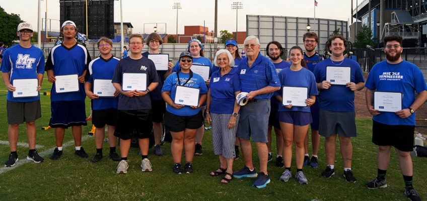 Don and Hanna Witherspoon, front center, pose with Middle Tennessee State University Band of Blue students on Aug. 21, 2026, just outside the football and baseball stadiums on campus in Murfreesboro, Tenn. The students received scholarships during the final evening of band camp. The Witherspoons were among donors to the “Where Every Note Counts” campaign invited to meet scholarship recipients and see firsthand the impact of their support. (MTSU photo by Mike Davis)