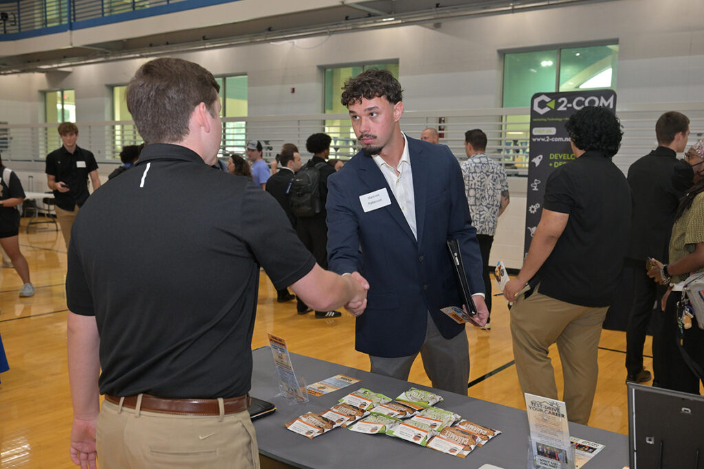Matthew Patterson, center, a finance major at Middle Tennessee State University in Murfreesboro, Tenn., shakes hands with a recruiter from the Southern Hospitality Internship Program during the annual Big Career Fair on Thursday, Sept. 24, 2026, in the Campus Recreation Center. (MTSU photo by James Cessna)