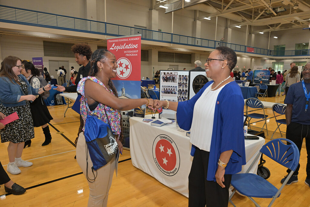 Kennedy Garrett, left, a political science major and president of the Student Government Association at Middle Tennessee State University in Murfreesboro, Tenn., bumps fists with a recruiter from the Tennessee General Assembly Legislative Internship Program during the annual Big Career Fair on Thursday, Sept. 24, 2026, in the Campus Recreation Center. (MTSU photo by James Cessna)
