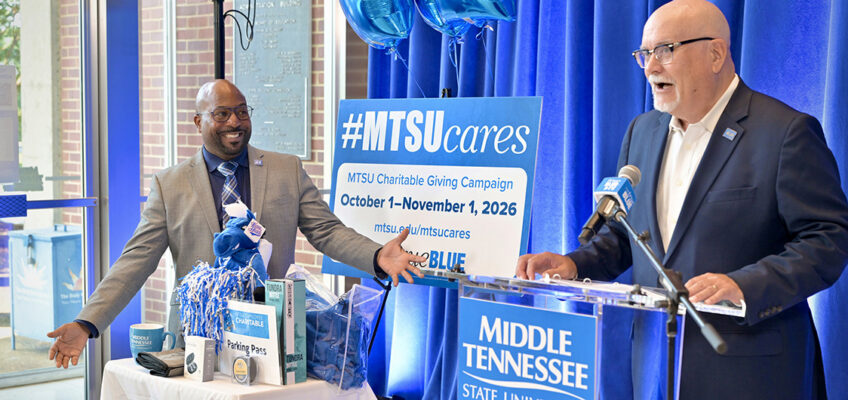 Andrew Oppmann, right, vice president for marketing and communications at Middle Tennessee State University in Murfreesboro, Tenn., talks about the weekly drawings and giveaways for the 2026-27 Employee Charitable Giving Campaign at the campaign kickoff in mid-September in the Cope Administration Building lobby. At left, standing behind some of the prizes, is James Bridgeforth, vice president for student affairs and dean of students. (MTSU photo by J. Intintoli).