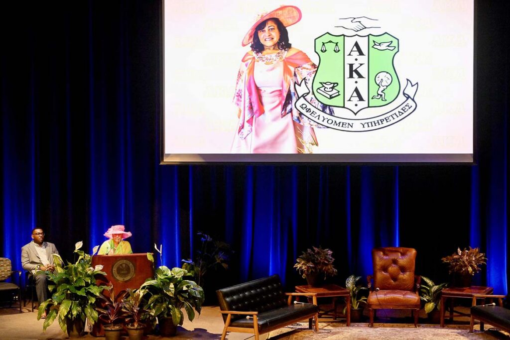 Phyllis Washington, a retired Rutherford County Schools administrator, gives a loving tribute to her longtime friend and fellow Alpha Kappa Alpha sorority sister, the late Middle Tennessee State University First Lady Elizabeth McPhee, pictured in the overhead screen, to open the Constitution Day keynote event held Thursday, Sept. 17, in Tucker Theatre on campus in Murfreesboro, Tenn. (MTSU photo by Andy Heidt)