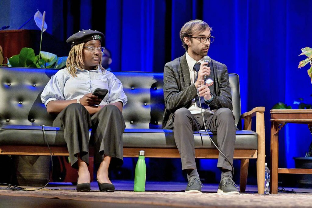 Middle Tennessee State University student and American Democracy President Marcus Rosario of Nashville, Tenn., right, asks a question as one of the student moderators for a panel discussion with nationally recognized legal scholar and Georgetown University law professor Sheryll Cashin as part of the annual Constitution Day observance held Thursday, Sept. 17, 2026, inside Tucker Theatre on campus in Murfreesboro, Tenn. Looking on, at left, is fellow moderator DeAsia Powell of East Ridge, Tenn., and ADP social media manager. (MTSU photo by Andy Heidt)