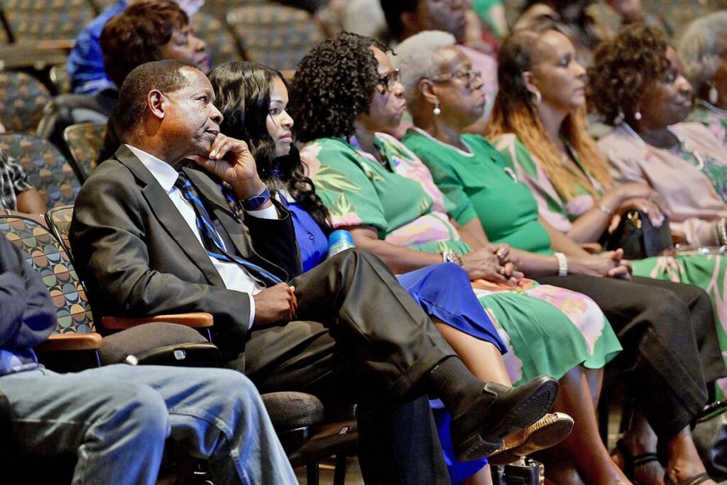 Middle Tennessee State University President Sidney A. McPhee, far left, seated beside his daughter, Seneca McPhee, as well as a group of Alpha Kappa Alpha Sorority members, listen to a loving tribute to the late MTSU First Lady Elizabeth McPhee by local educator and longtime friend Phyllis Washington, as part of the annual Constitution Day observance held Thursday, Sept. 17, 2026, inside Tucker Theatre on campus in Murfreesboro, Tenn. Mrs. McPhee died unexpectedly in January following a brief illness. (MTSU photo by Andy Heidt)
