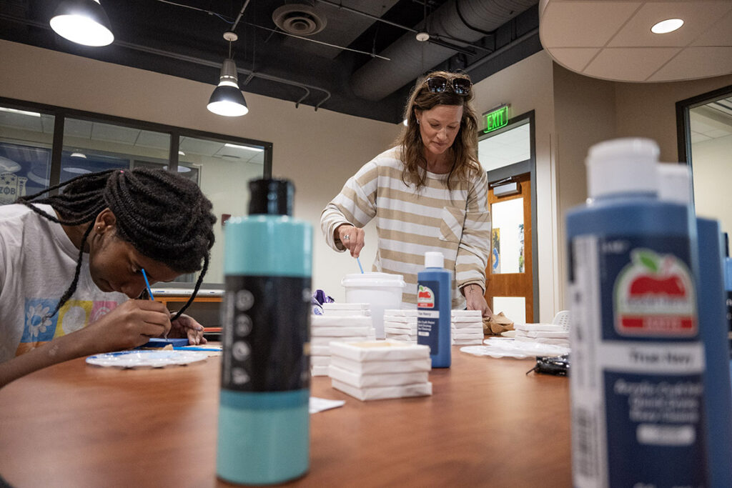 Amariah Woods, an aerospace major from Memphis, left, and Lisa Benzinger, an administrative assistant in the advising office of the College of Liberal Arts and digital media master’s student, work on tiny canvases as part of a community art project for Middle Tennessee State University’s new Craft Center, which opened Sept. 8, 2026, on the second floor of the Student Union Building in Murfreesboro, Tenn. (MTSU photo by Cat Curtis Murphy)
