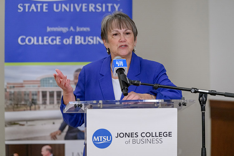 Woman speaking at podium.