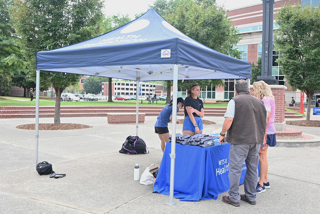 Representatives of the Health Promotions office at Middle Tennessee State University speak with visitors at their recent Overdose Awareness Day tabling event in the quad area on campus in Murfreesboro, Tenn.
