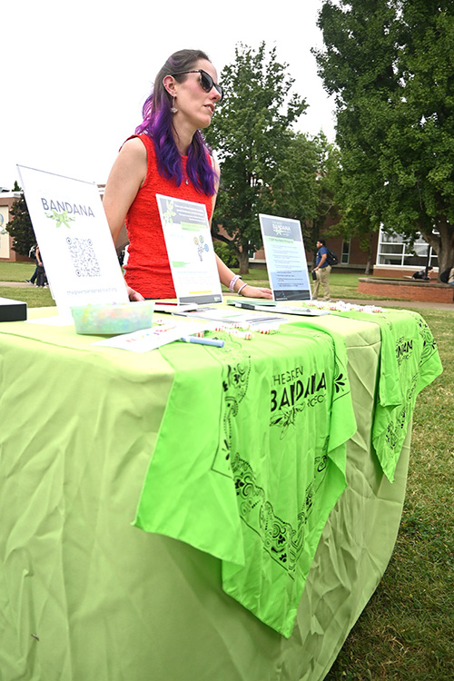Channing Phillips with Middle Tennessee State University Counseling Services speaks with students about the Green Bandana Project in the quad area on campus in Murfreesboro, Tenn. The initiative trains students to provide mental health peer support.