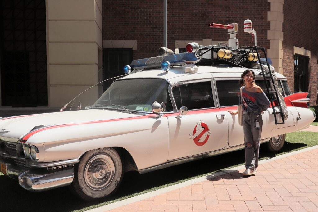 Jazz Suarez, a senior animation major at Middle Tennessee State University in Murfreesboro, Tenn., stands beside the iconic car from the “Ghostbusters” franchise during her internship at Sony Pictures Animation in Los Angeles, Calif., over the summer. (Submitted photo)