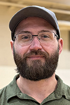 Kyle Bernet, Amazon manager, wearing a baseball cap and glasses.