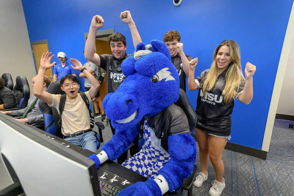 Students inside the newly expanded Esports Level Up Arena on Middle Tennessee State University’s Murfreesboro, Tenn., campus cheer on university mascot Lightning as he plays a video game in the casual gaming space of the arena, which held a ribbon cutting on Tuesday, Sept. 22, 2026, on the first floor of the Student Union Building. (MTSU Photo by J. Intintoli)