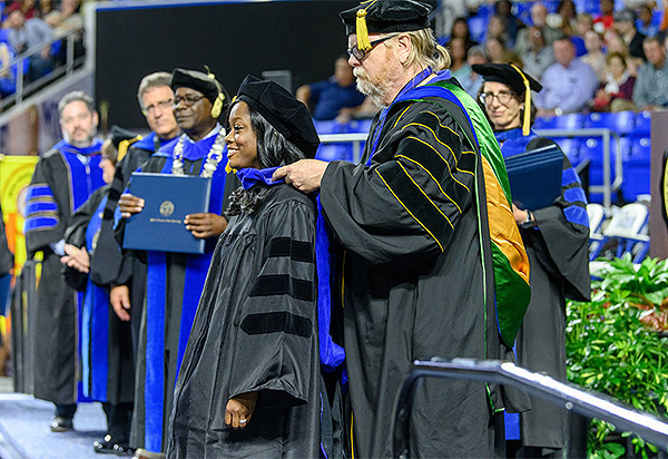Tiffany Momon, new director of the Center for Historic Preservation at Middle Tennessee State University in Murfreesboro, Tenn., receives her doctorate from mentor and longtime center director, Carroll Van West, during the MTSU commencement in 2019. In addition to her work at the center, she created the Black Craftspeople Digital Archive to document the often overlooked contributions of enslaved and freed Blacks on architecture, handcrafts and decorative arts of the American South. (MTSU file photo by Andy Heidt)