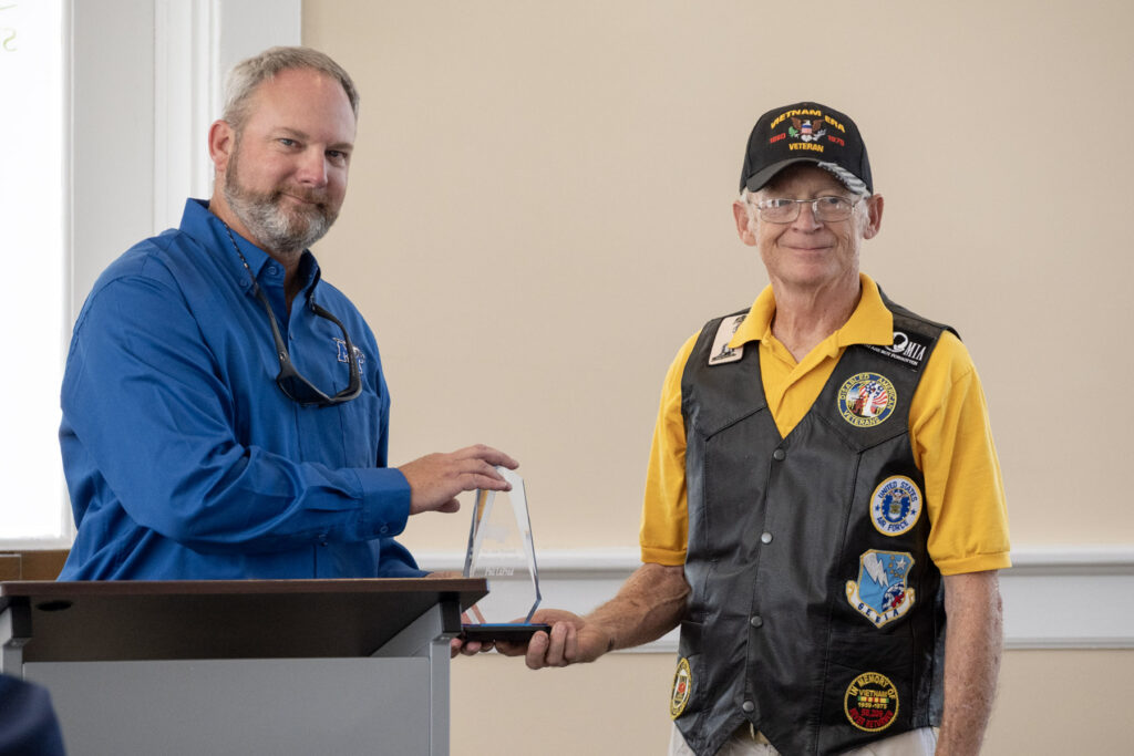 Trey Nunley, left, grandson of World War II U.S. Army veteran and Middle Tennessee State University alum Joe Nunley, presents the Joe Nunley Distinguished Veteran Award to “Mobile Phil” LaPrad during MTSU’s Veterans Memorial Service ahead of the university’s annual Salute to Veterans and Armed Forces football game on Sept. 19, 2026, in Murfreesboro, Tenn. (MTSU Photo by Cat Curtis Murphy)